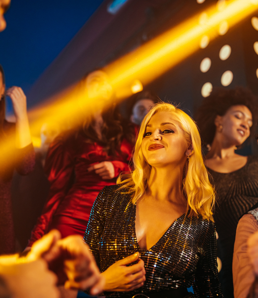 Group of energetic young people dancing at a party in a nightclub